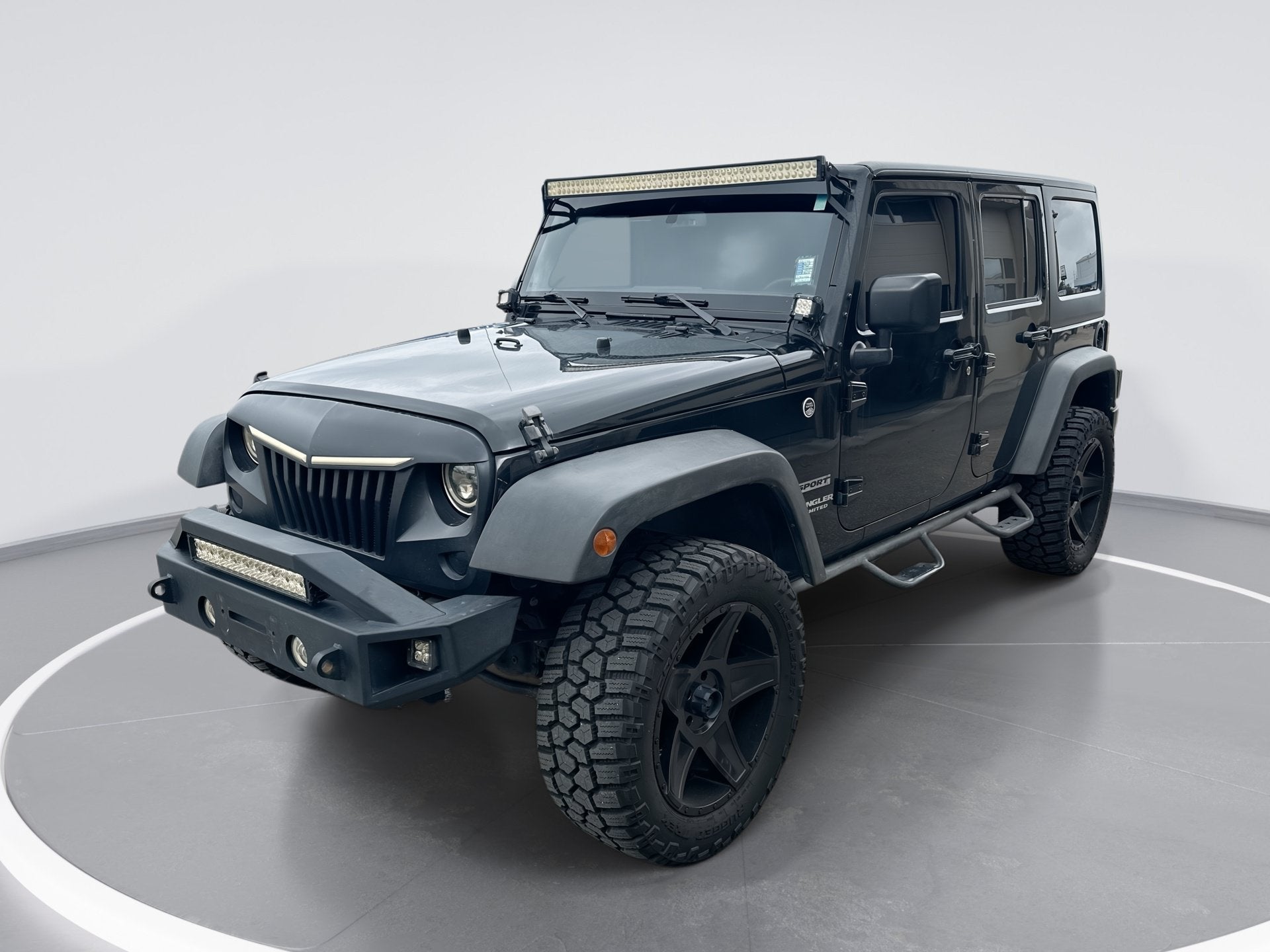 2016 Jeep Wrangler Unlimited Sport in Black Clearcoat — front three-quarter view