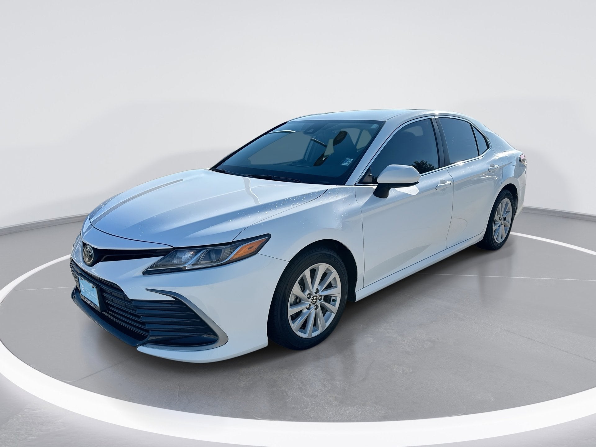2021 Toyota Camry LE in Super White — front three-quarter view
